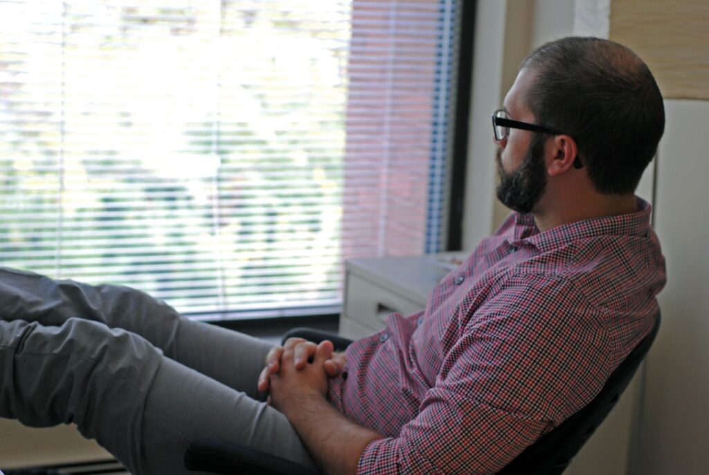 Man looking out window