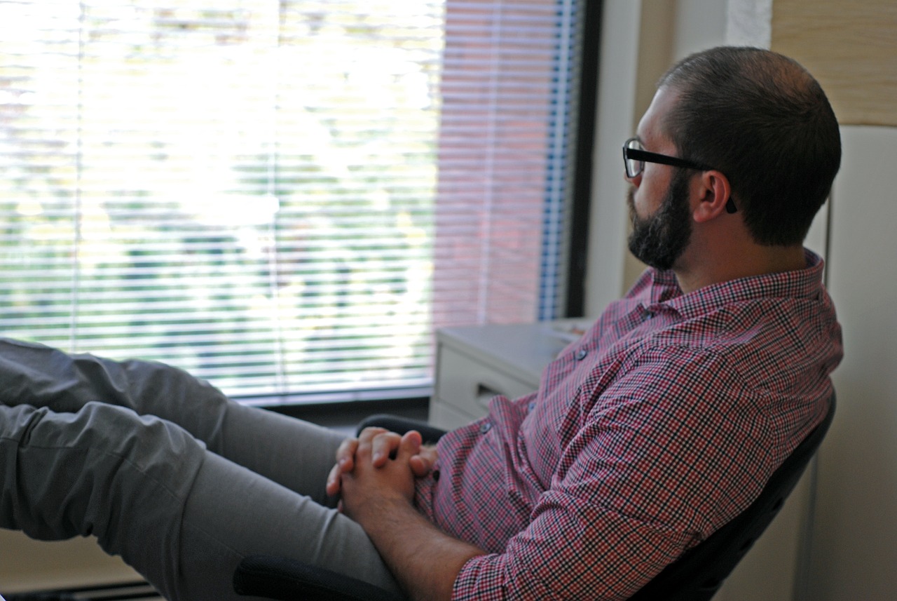 Man looking out window