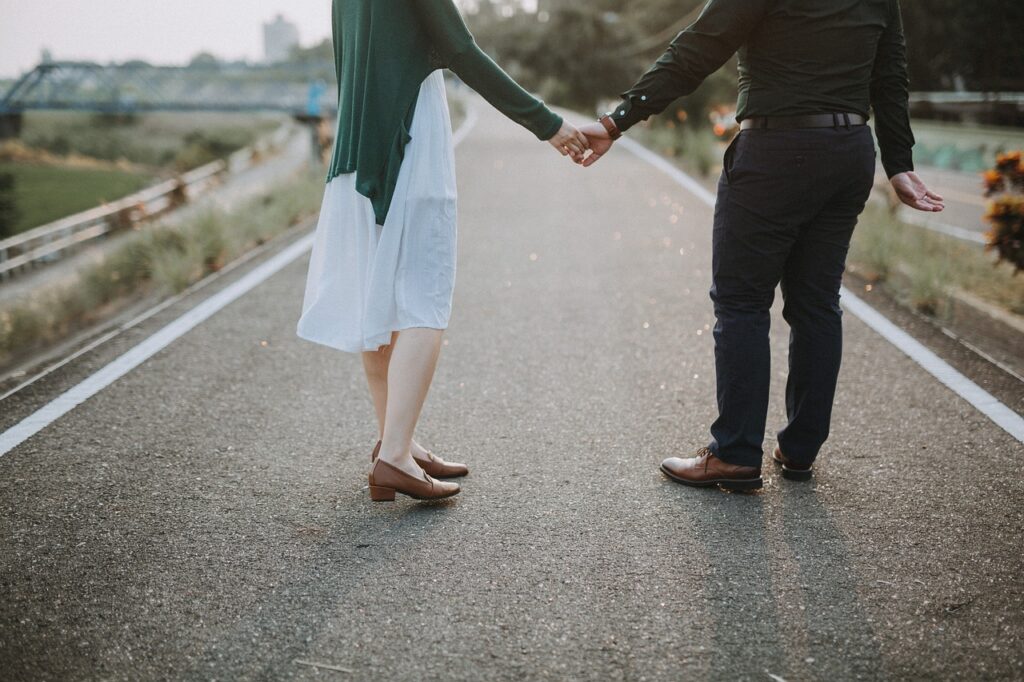 Couple holding hands on sidewalk
